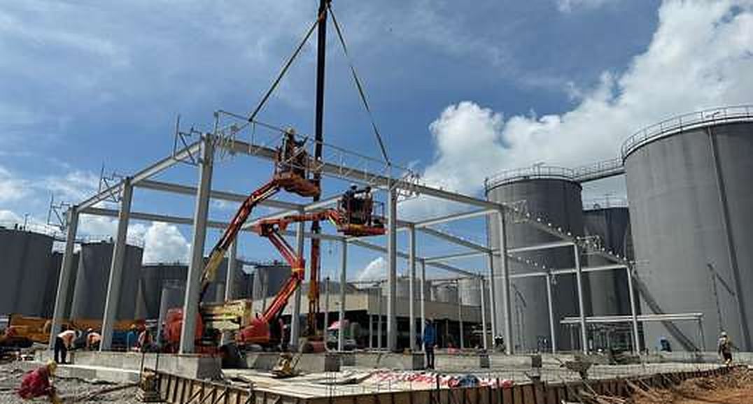 Steel portal frames erected beside a tank farm